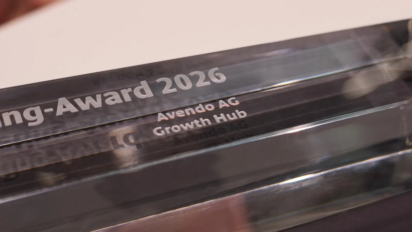 Nahaufnahme der Glasgravur «Avendo AG – Growth Hub» auf der Trophäe